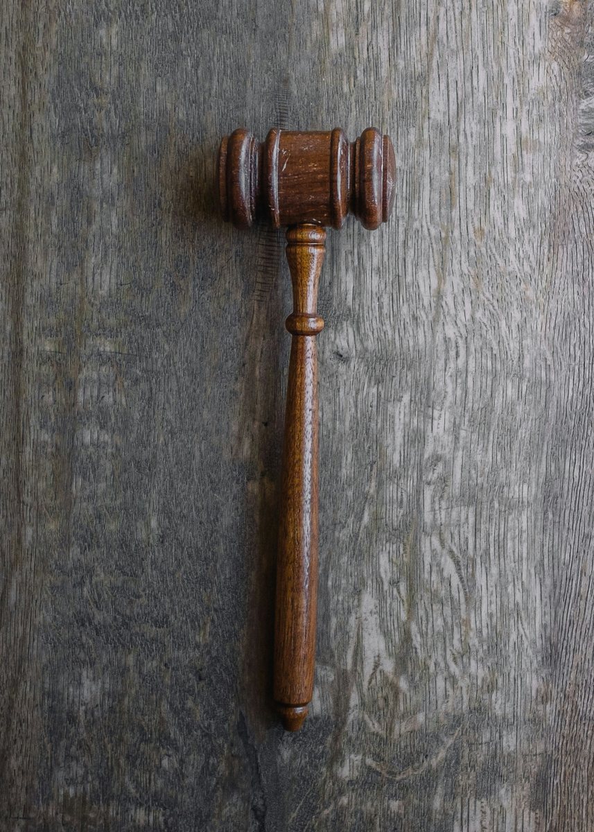 Wooden auction gavel on a textured surface